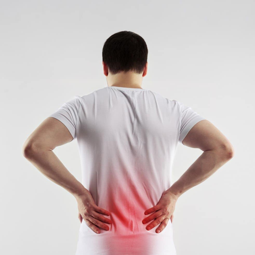 Man rubbing his lower back in pain