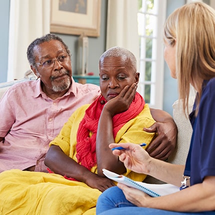 Concerned african-american couple speaking with therapist